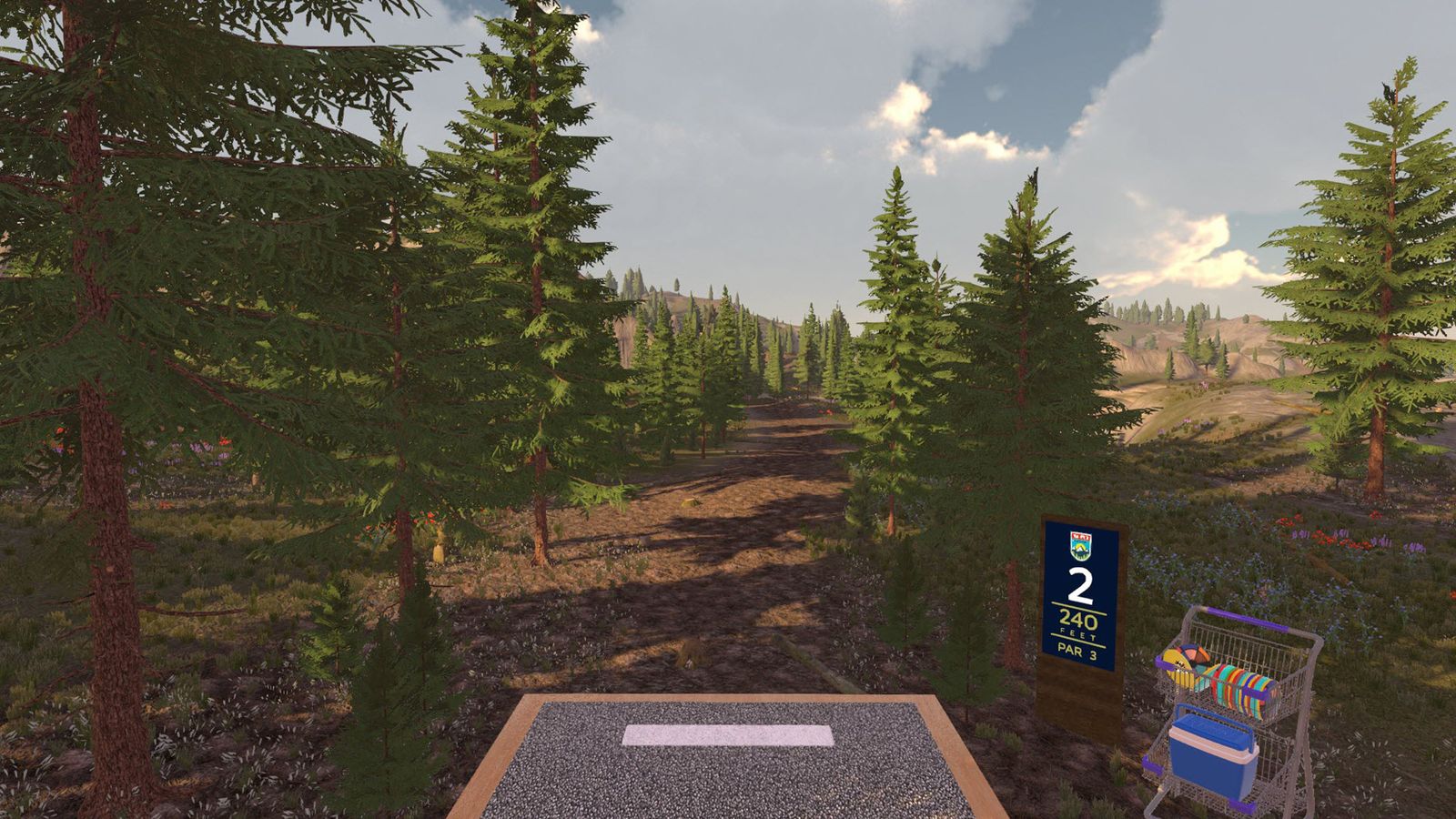 Tee pad with a disc golf bag beside the hole 2 sign